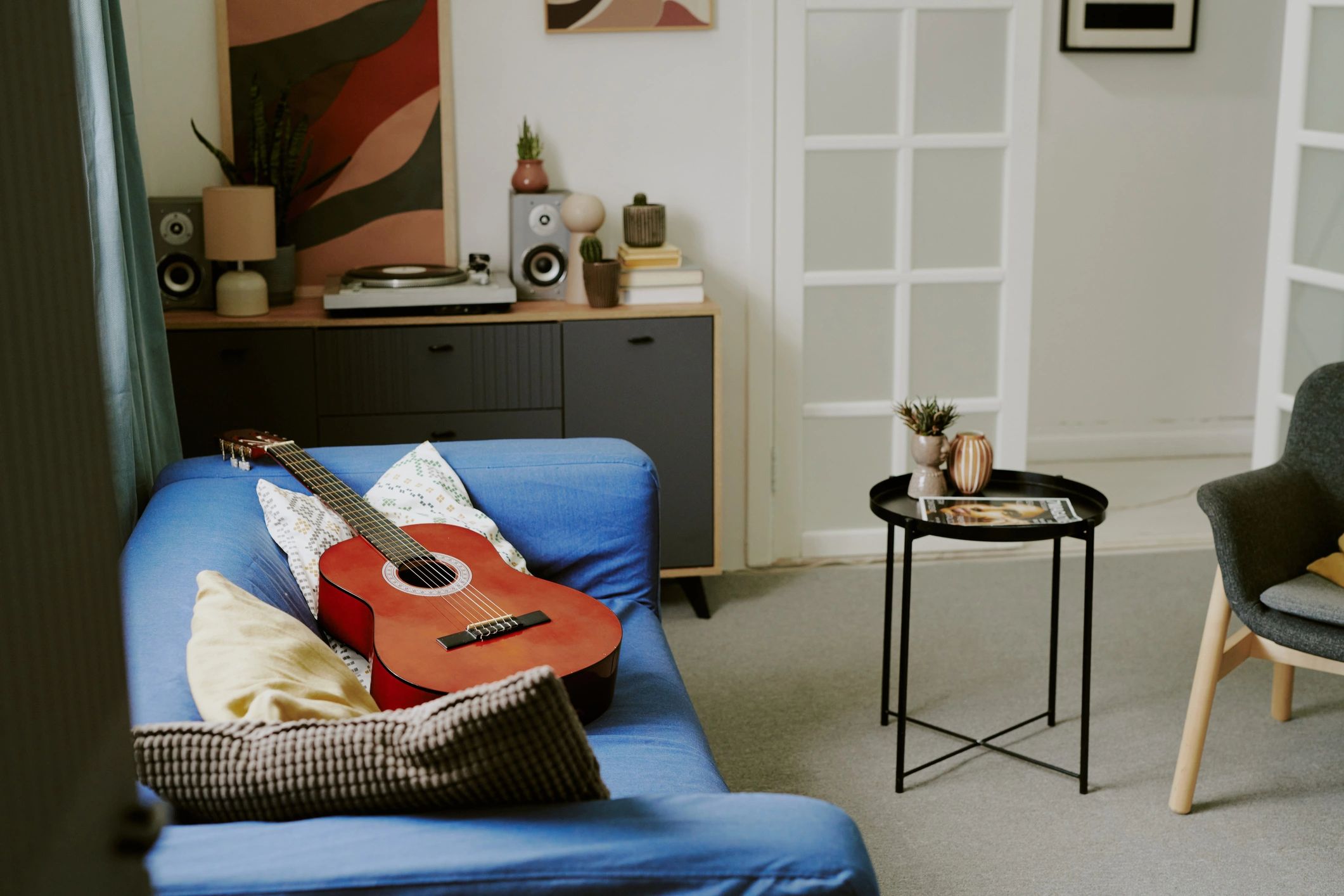 Acoustic guitar resting on a sofa